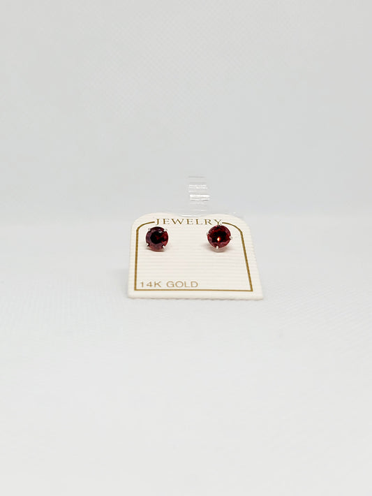 Aretes redondos con topacio rojo en oro blanco de 14 k